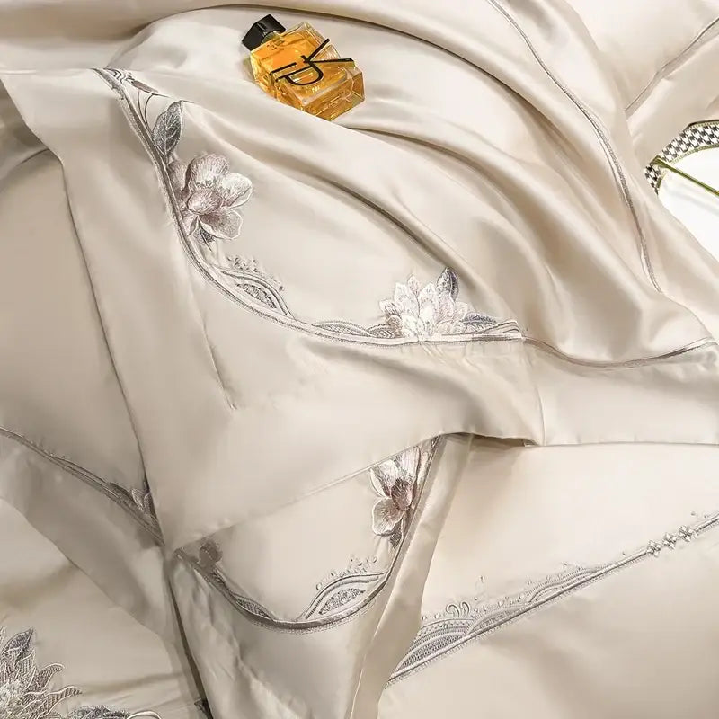 Cream-colored satin duvet cover with silver floral embroidery edges from decorbites chic flowers embroidery bedding set