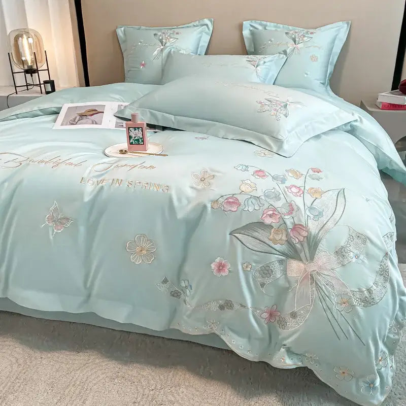 Light blue satin-like bedding set with decorbites chic flowers embroidery in pink white and gold 100% egyptian cotton