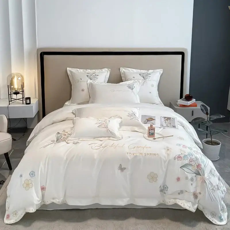 White satin-like bedding set with delicate pastel floral and butterfly embroidery from decorbites chic flowers embroidery collection