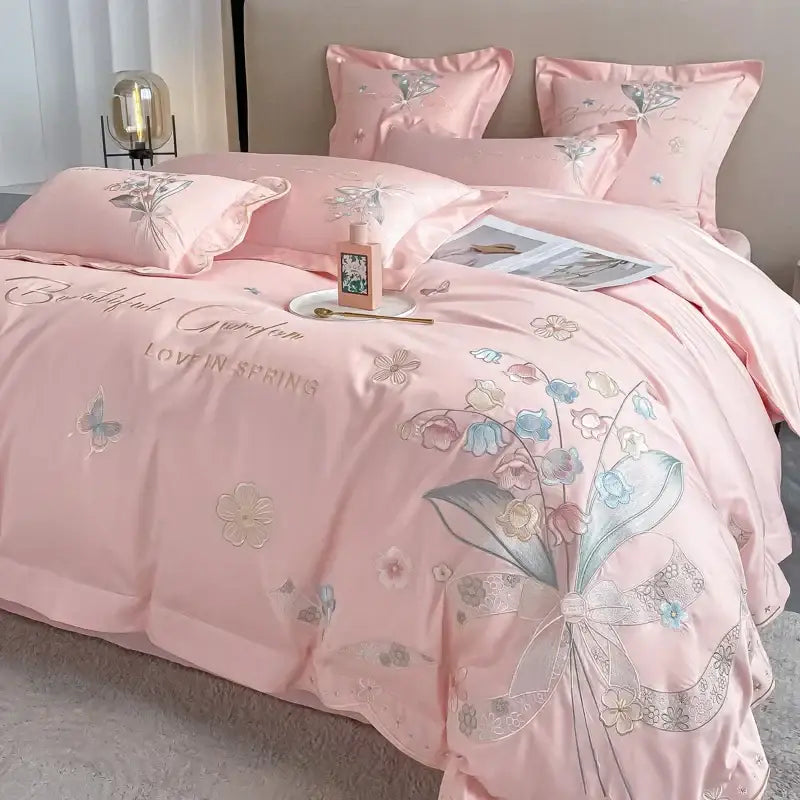 Pink satin bedding set with chic flowers embroidery featuring delicate floral and butterfly details in 100 percent egyptian cotton by decorbites