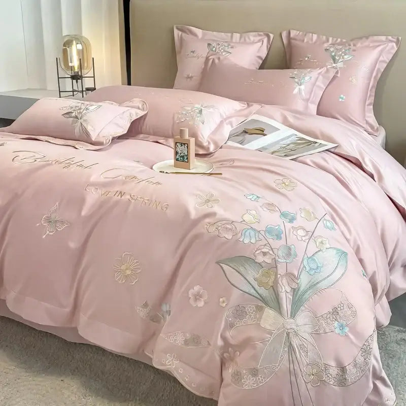 Pink satin bedding set with delicate floral embroidery and bow design from decorbites chic flowers embroidery collection