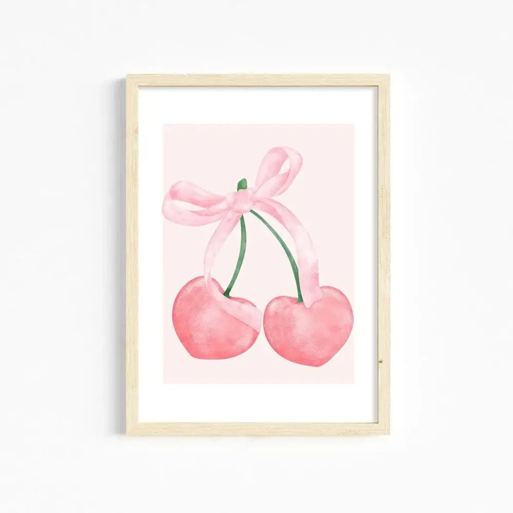 A framed watercolor print of two pink heart-shaped cherries tied with a pink ribbon bow for pink wall art