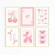 Set of six framed watercolor pink wall art prints featuring cherries, bows, cards, butterflies, and balloon dog for girls room