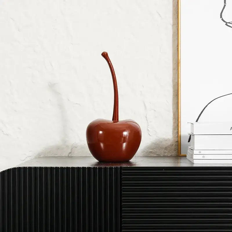 A glossy deep red cherry resin ornament with a long stem from decorbites chic red chic red cherries collection
