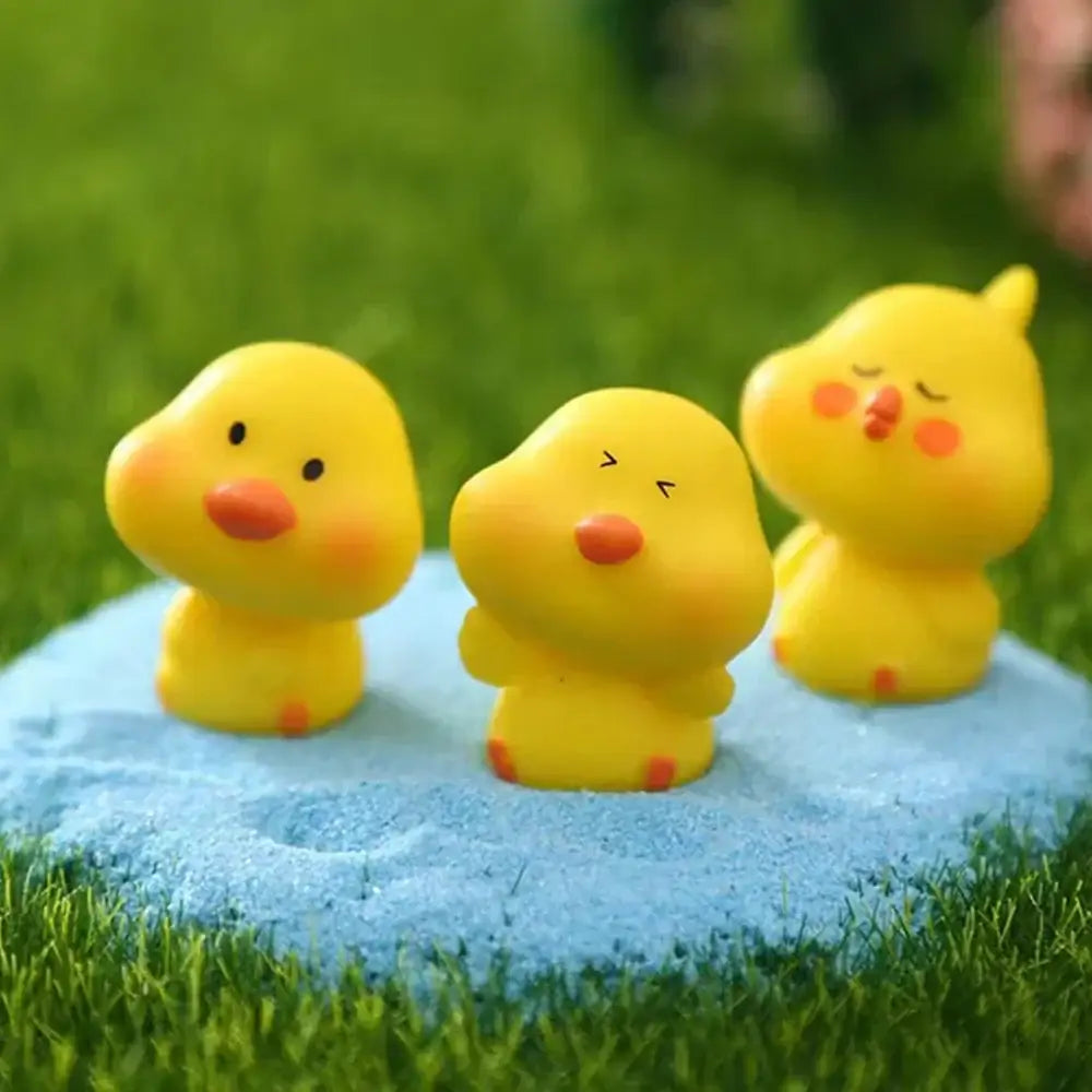 Three yellow decorbites chick doll figurines with unique facial expressions for miniature fairy house decor