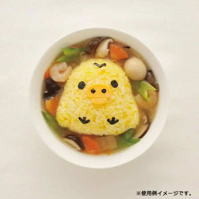 A yellow rice ball shaped rilakkuma character made with the decorbites chicken bear mold set featuring seaweed details