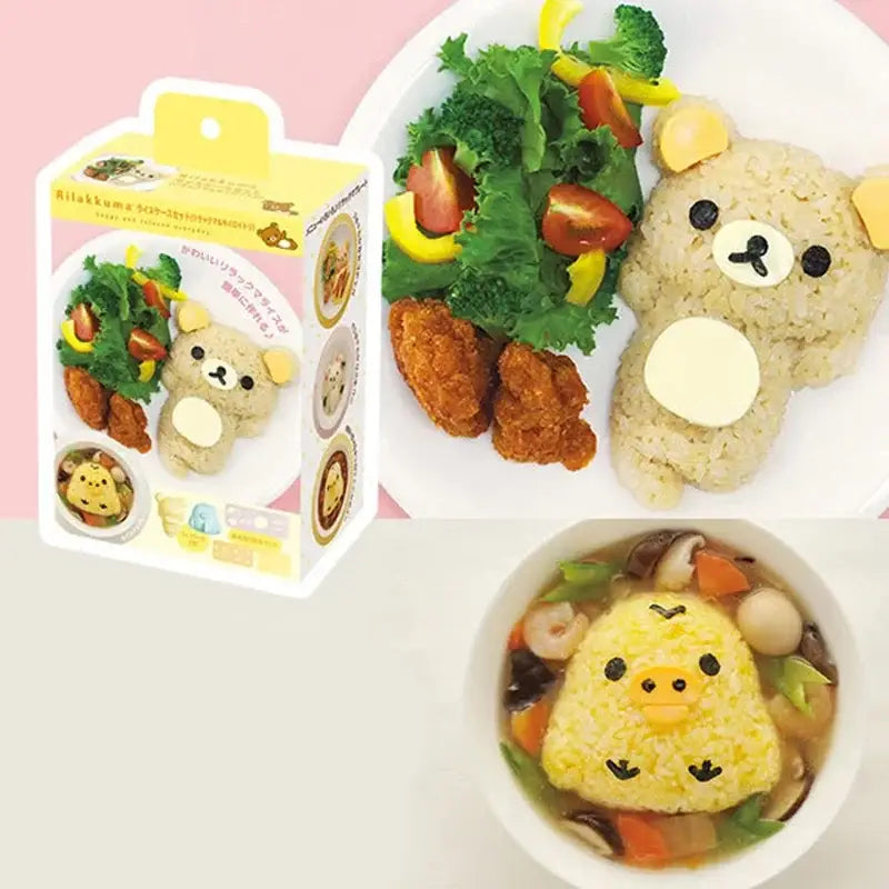 A cute yellow rilakkuma-shaped rice ball with black eyes and white belly made using the decorbites chicken bear mold set