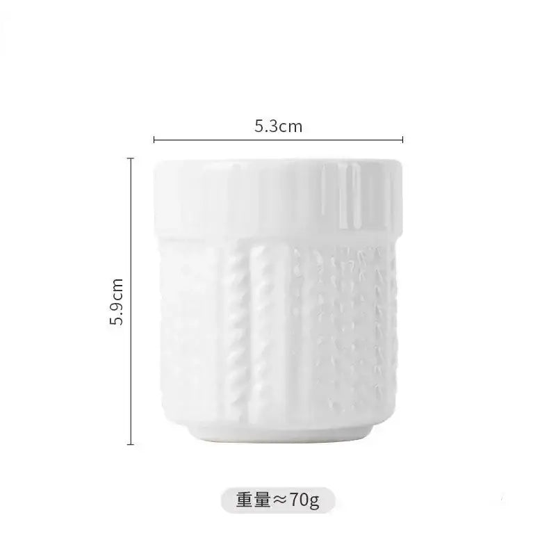 White ceramic egg cup holder with textured vertical ridges and slightly flared rim for kids breakfast use