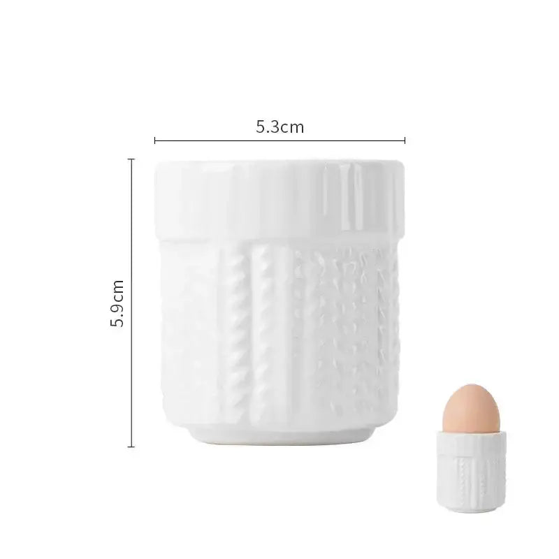 White ceramic DecorBites egg cup holder with textured ribbed design and matching lid for kids breakfast tableware