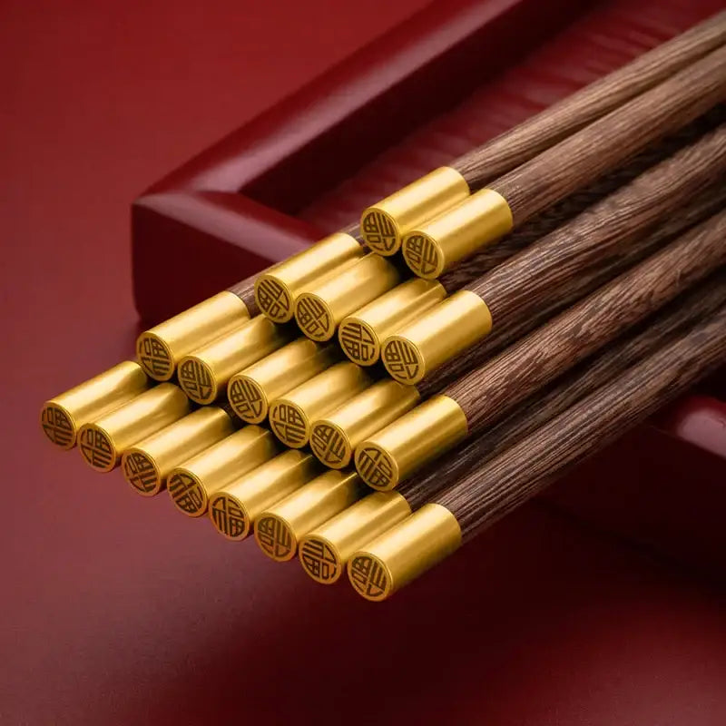 Decorbites™ chicken-wing wood chopsticks set with dark wood and polished gold caps engraved with chinese characters