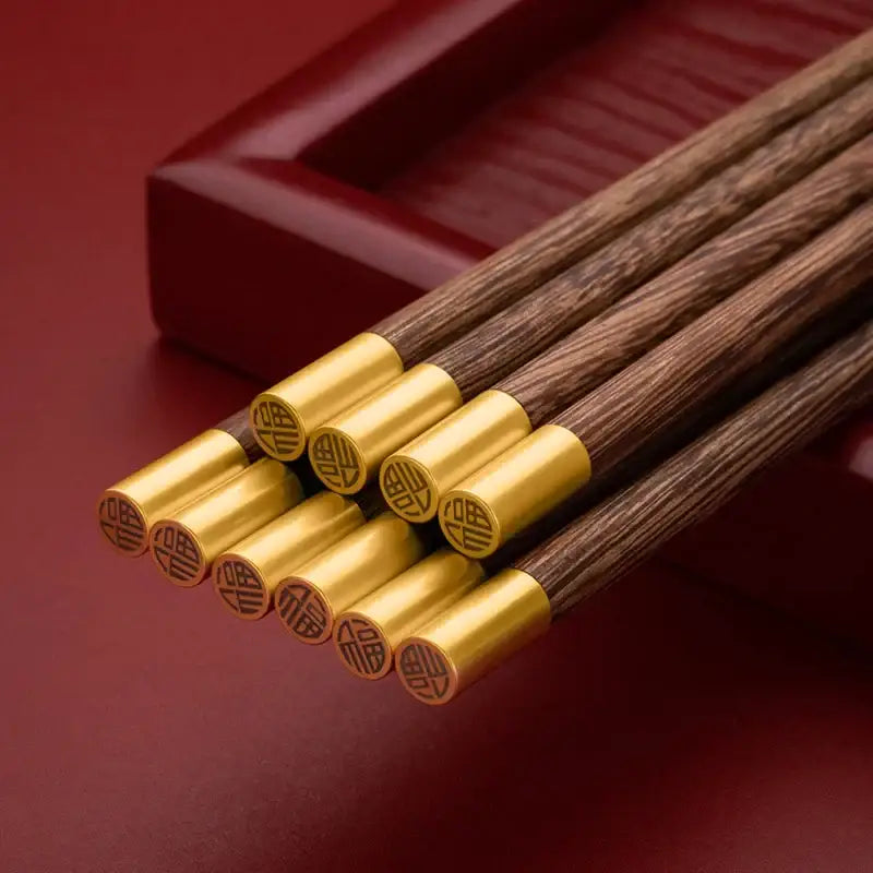 Decorbites™ chicken-wing wood chopsticks set with dark wood and polished gold metal tips engraved with chinese characters