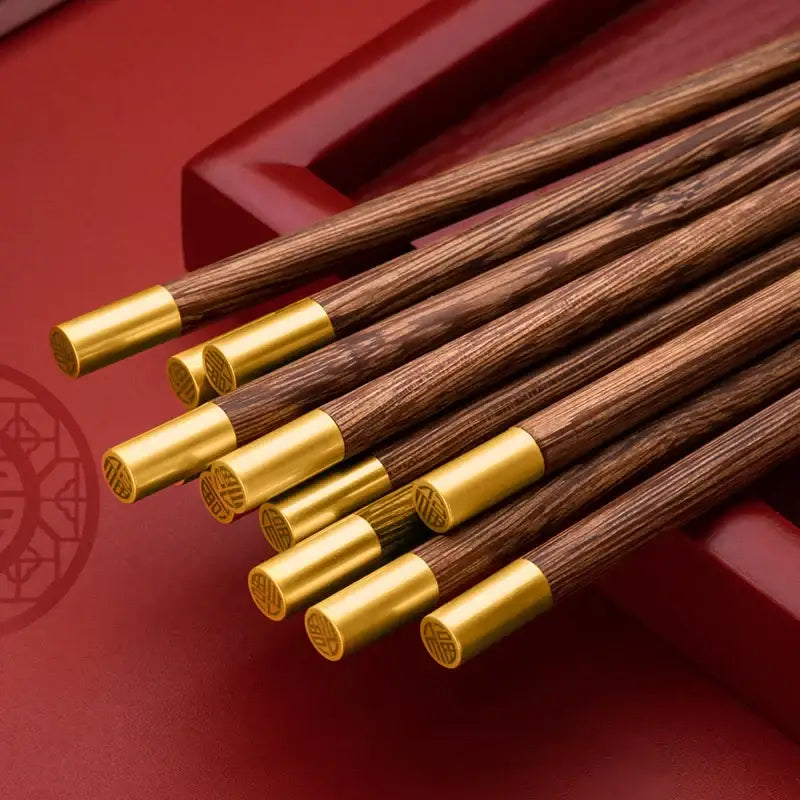 Set of elegant decorbites™ chicken-wing wood chopsticks set with dark wood and gold metal engraved tips