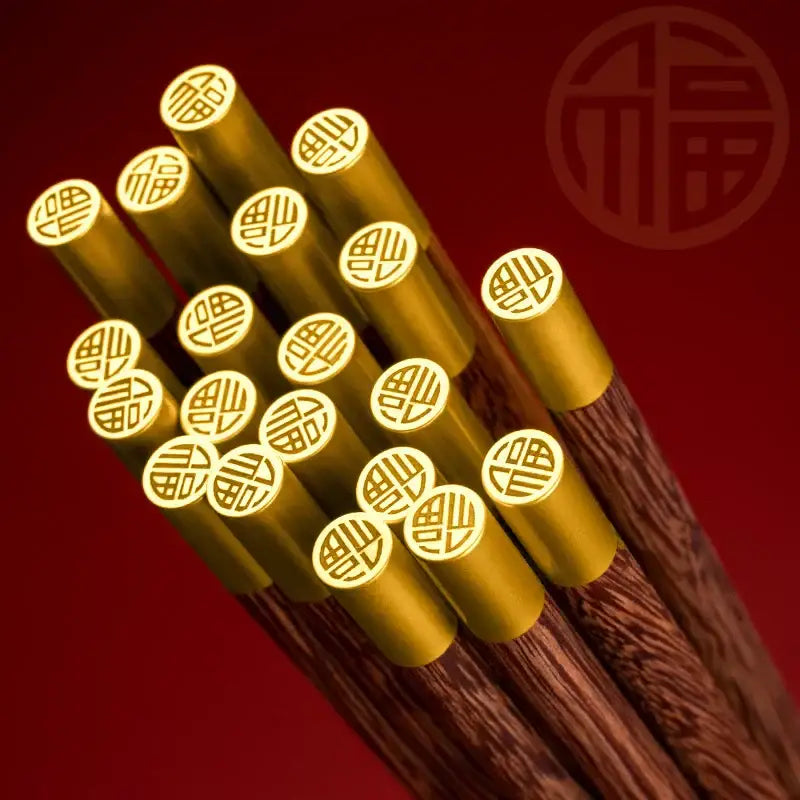 Golden-tipped decorbites™ chicken-wing wood chopsticks set with intricate chinese character engravings on ends
