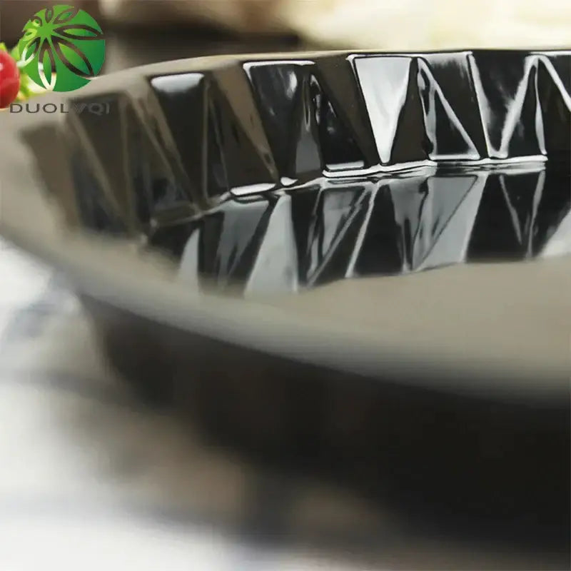Black ceramic chiffon cake mold with a glossy geometrically patterned rim from decorbites chiffon cake mold set