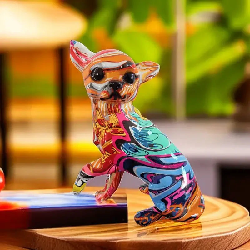 A vibrant resin chihuahua dog ornament with glossy graffiti patterns in pink teal orange and black for home decor