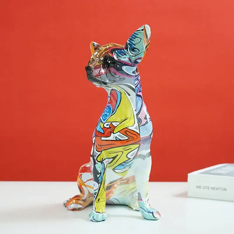 A vibrant decorbites chihuahua dog sculpture with bold multicolored patterns and a glossy resin finish