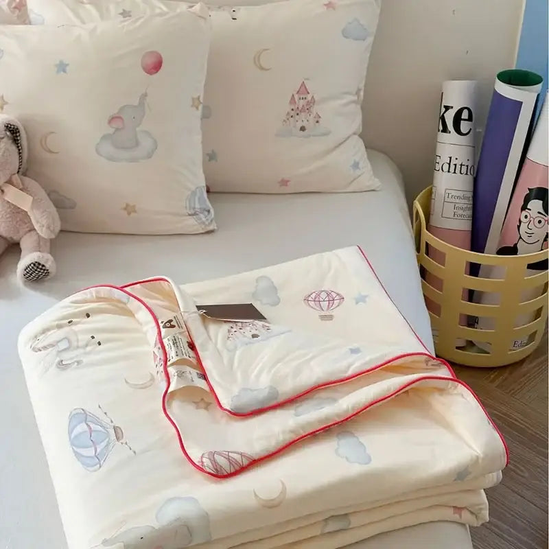 Cream-colored decorbites children cartoon quilt with pastel hot air balloons moons stars and red stitched border for summer use