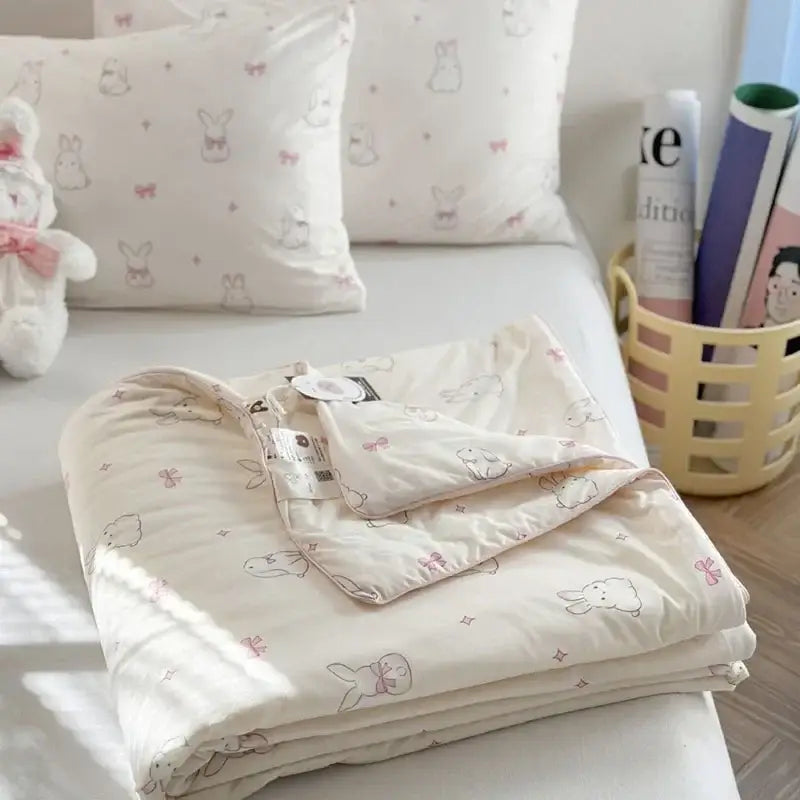 Cream-colored decorbites children cartoon summer cooling quilt with plush texture pastel pink bows and gray bunny illustrations