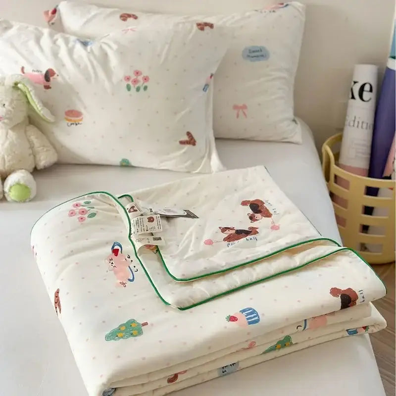 A cream-colored decorbites children cartoon summer cooling quilt with pastel animal patterns and green trim for double beds