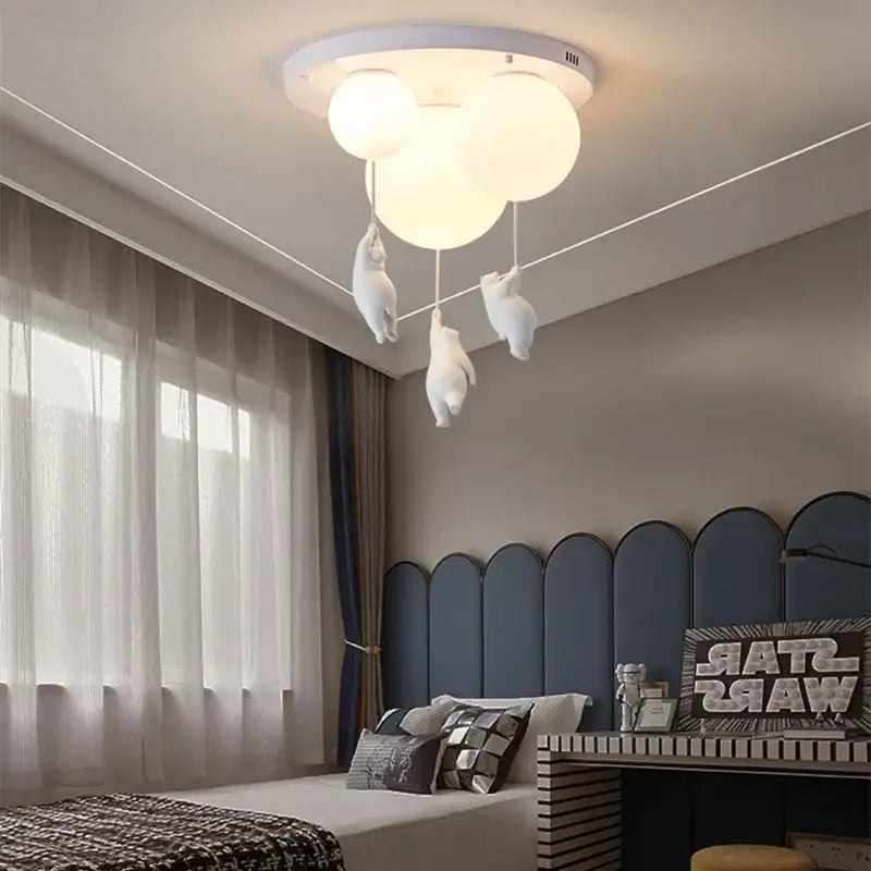 White ceiling chandelier with three spherical bulbs and dangling plush bear astronaut figures by decorbites children nordic