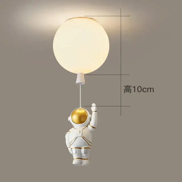 White bear astronaut figurine with gold accents holding glowing light in DecorBites children Nordic ceiling chandelier