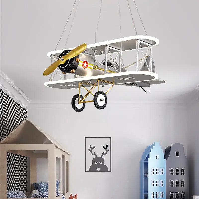 Decorbites™ children’s aircraft led chandelier shaped like a vintage silver biplane with gold propeller and landing gear