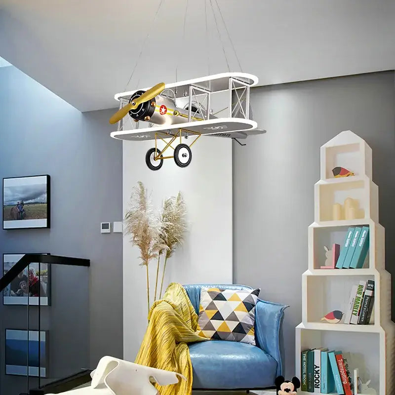 DecorBites™ children’s aircraft led chandelier shaped like a vintage silver biplane with gold propeller and white accents