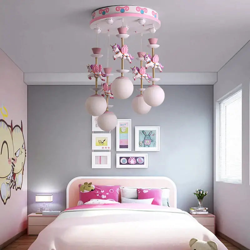 Pink and gold decorbites™ children’s carousel led chandelier with whimsical unicorn figurines and frosted globe lights