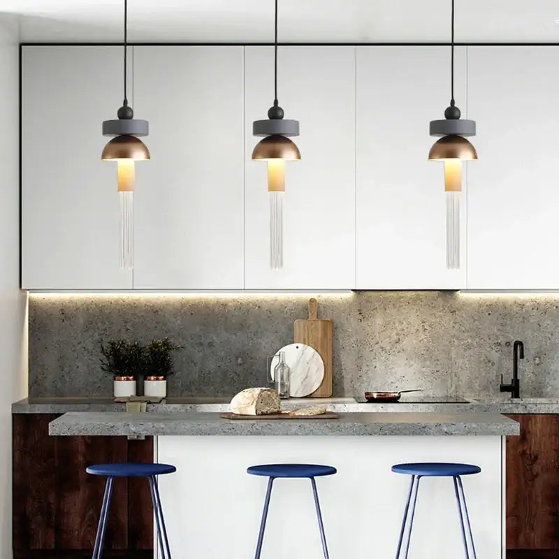 Decorbites™ children’s room glass pendant light with matte gray shades and brass tops hanging from black cords