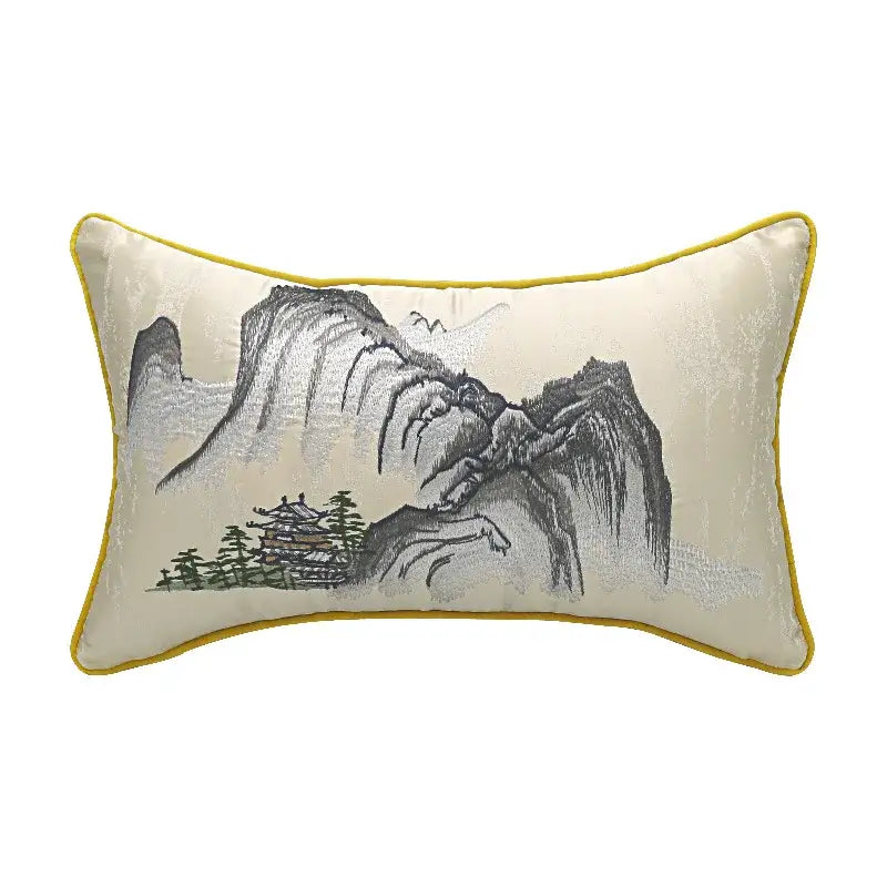 Cream-colored pillow cover with yellow border featuring chinoiserie landscape embroidered with mountains and traditional building