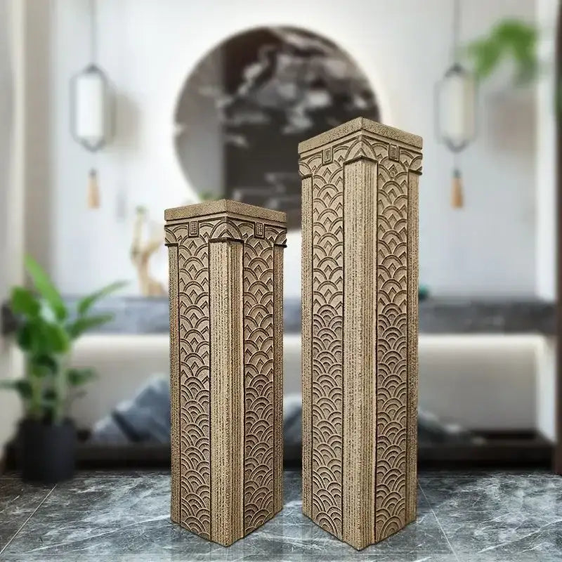 Two beige textured resin stake display columns with intricate scalloped and geometric carvings for decorBites garden and living room décor