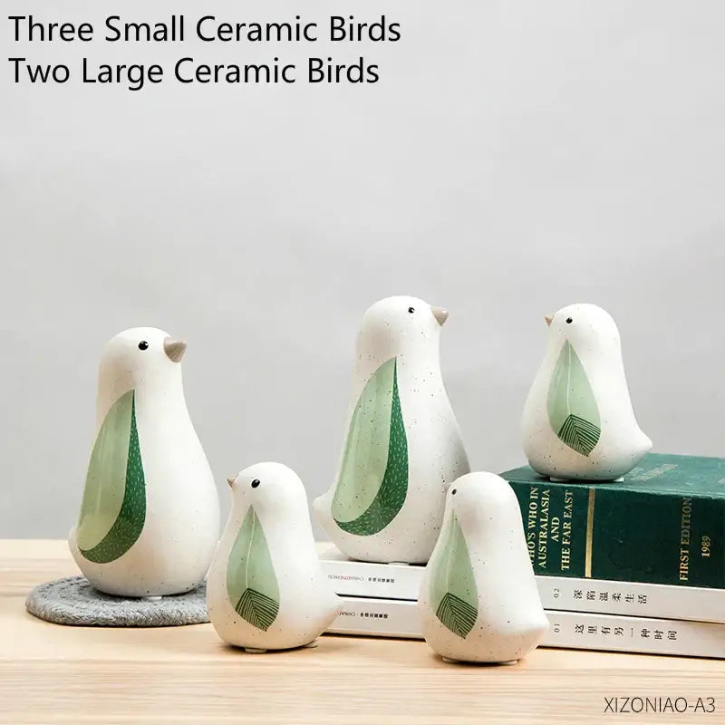 Set of five white speckled ceramic bird figurines with light green leaf wings for home decor by decorbites bird figurines