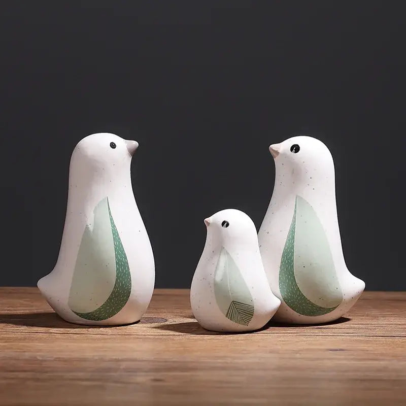 Set of three white ceramic bird figurines with green leaf-patterned wings for home decor by DecorBites bird figurines