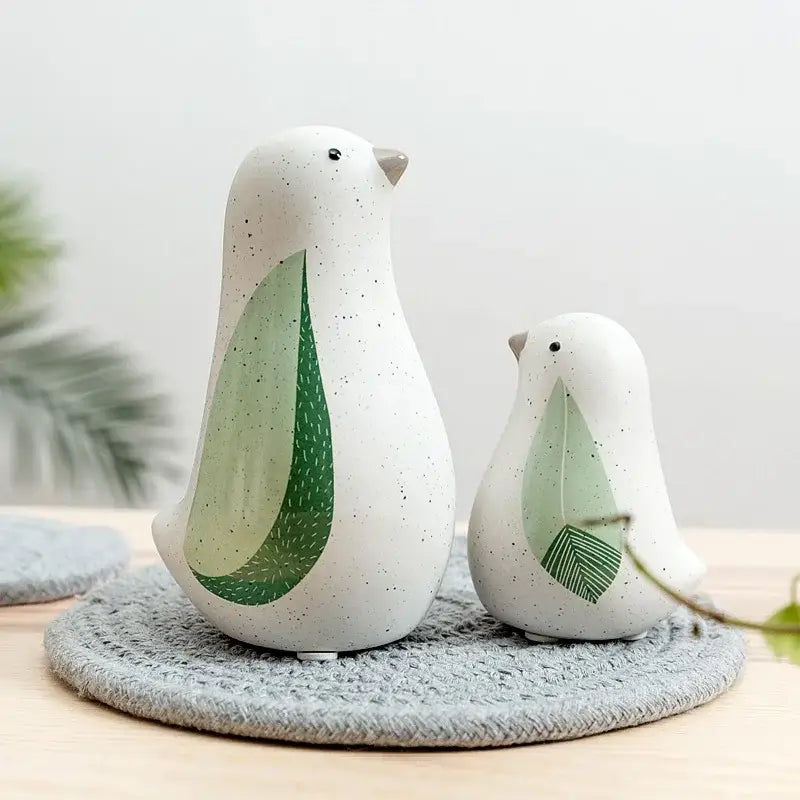 White ceramic bird figurines with speckled texture and green leaf patterned wings for home decor by decorbites bird figurines