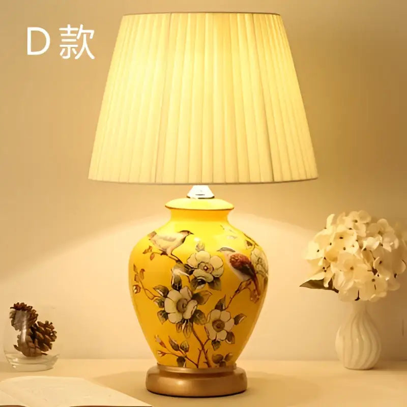 Yellow decorbites™ bird flower ceramic table lamp with hand-painted motifs and off-white pleated shade for bedroom use