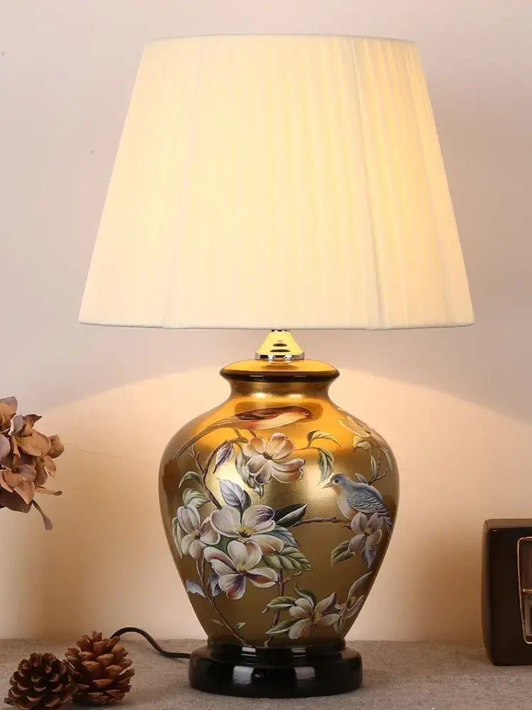 DecorBites™ golden bird flower ceramic table lamp with hand-painted motifs and cream pleated shade for bedroom use