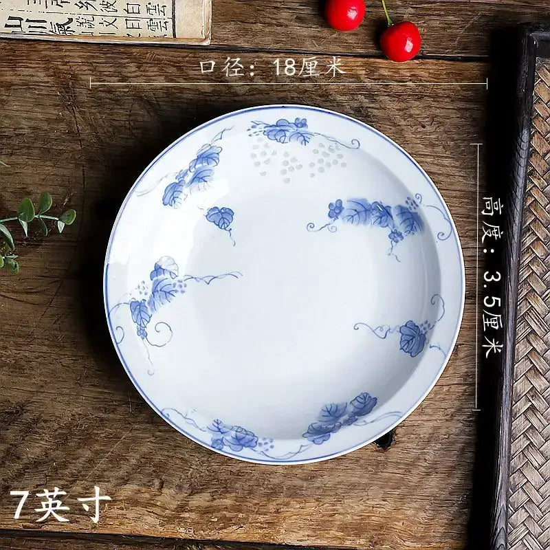 A white porcelain vegetable plate with blue floral vine patterns and glossy finish from DecorBites porcelain set