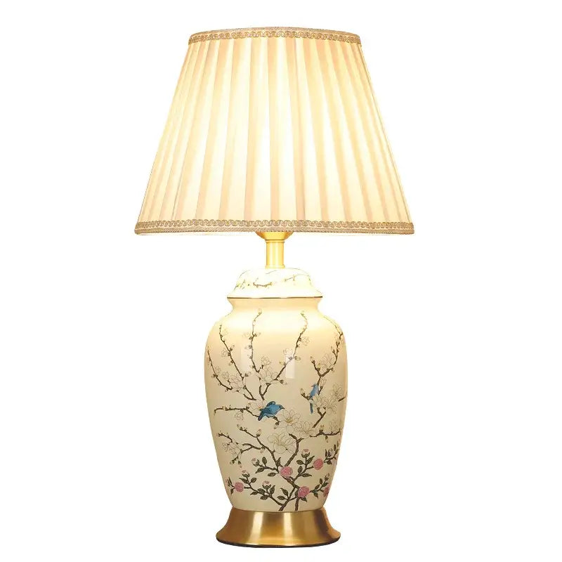 Decorbites™ cream ceramic table lamp with hand-painted blue birds pink blossoms and beige pleated shade with gold trim