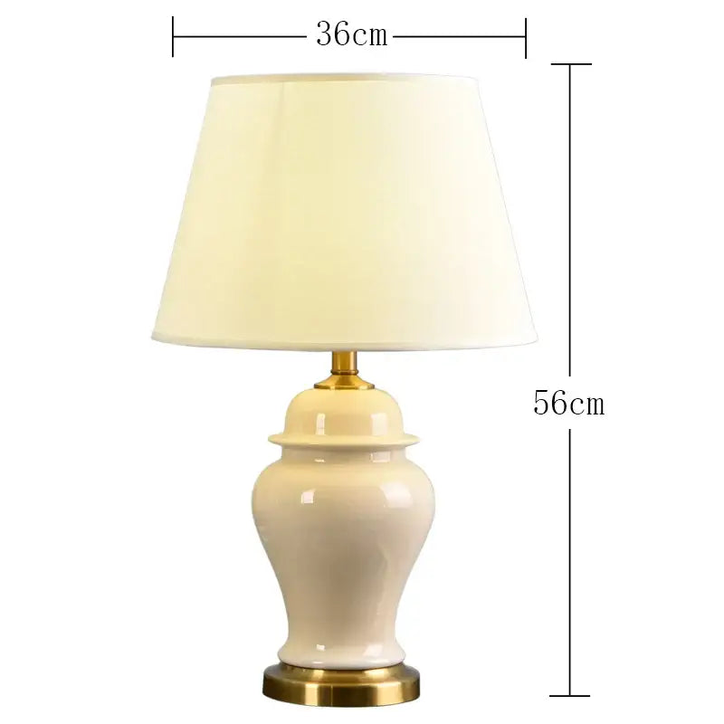 Cream-colored ceramic table lamp with gold metal base and off-white fabric shade from DecorBites ceramic table lamps