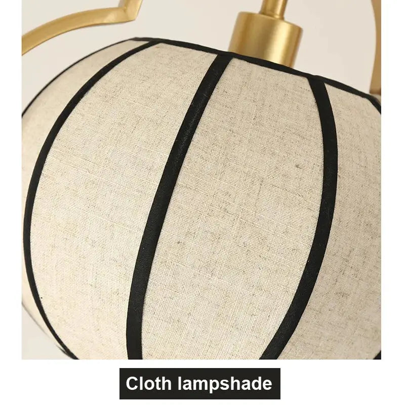 Beige linen pendant light with black stripes and gold fixture from DecorBites elegant tea house chandelier collection