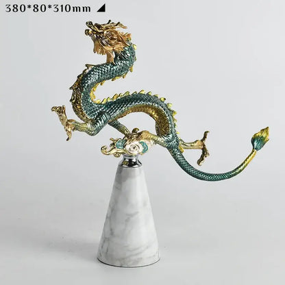 Detailed decorbites chinese dragon figurine with metallic green and gold accents on white marble base for home decor