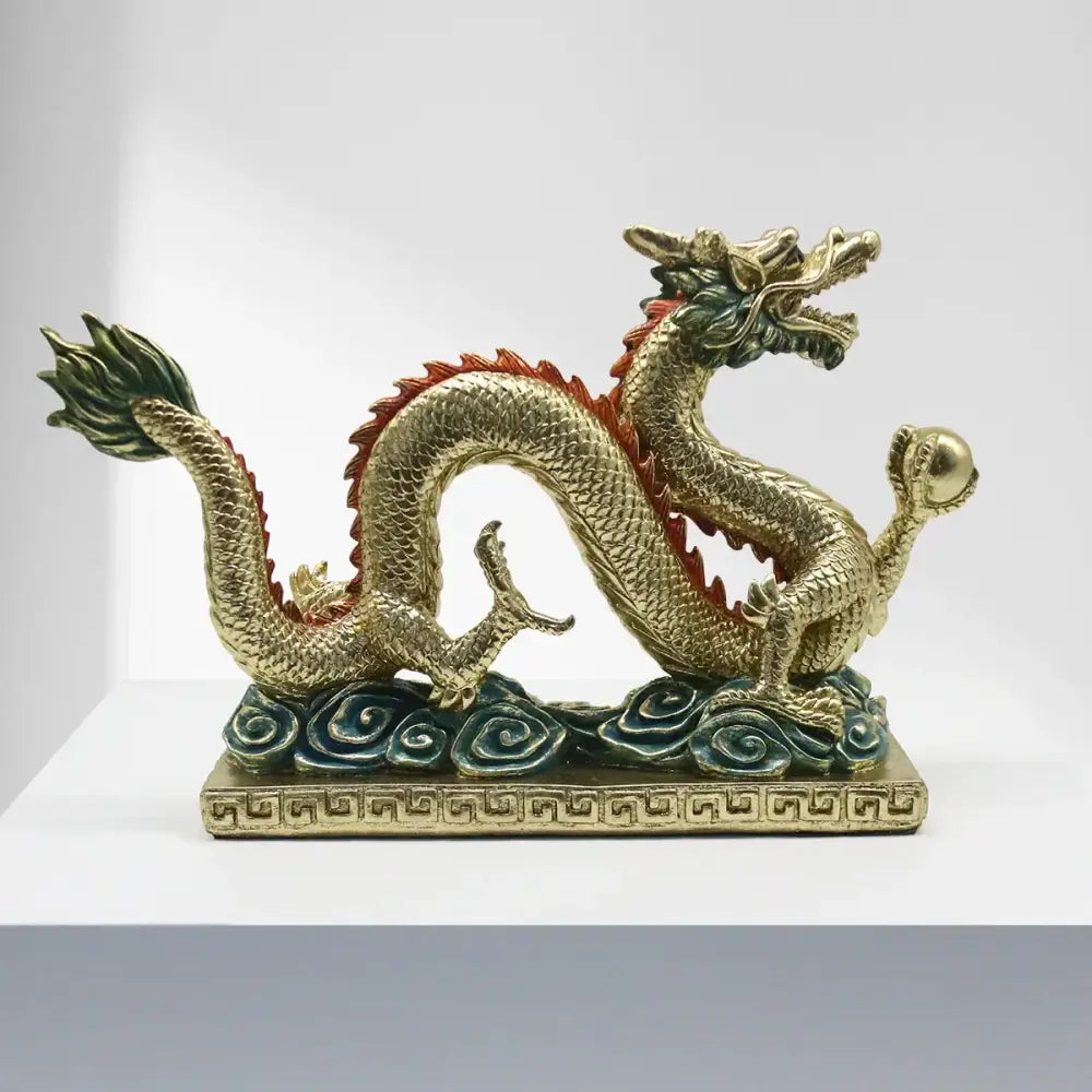 Golden chinese dragon resin sculpture with red and green accents detailed scales on decorative base by decorbites chinese dragon