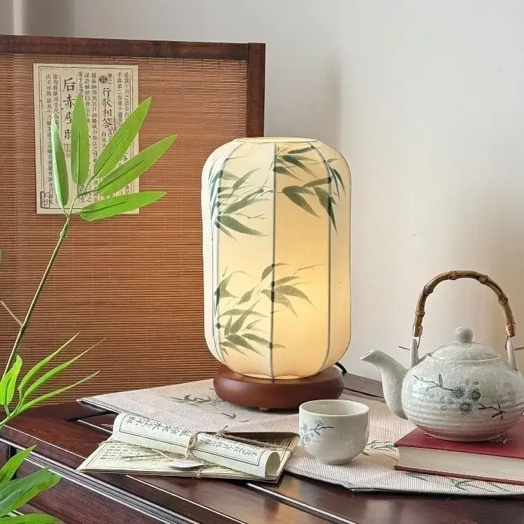 Warmly glowing cream chinese fabric desk lamp with bamboo leaf design on wooden base by decorbites chinese fabric
