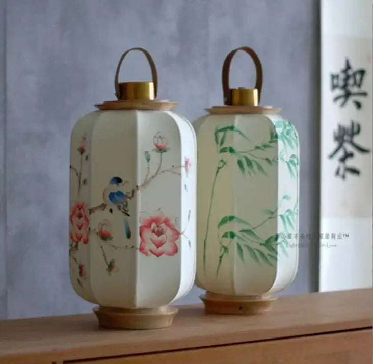 Two hand-painted decorbites chinese fabric desk lamps featuring blue bird and bamboo designs on wooden bases and handles