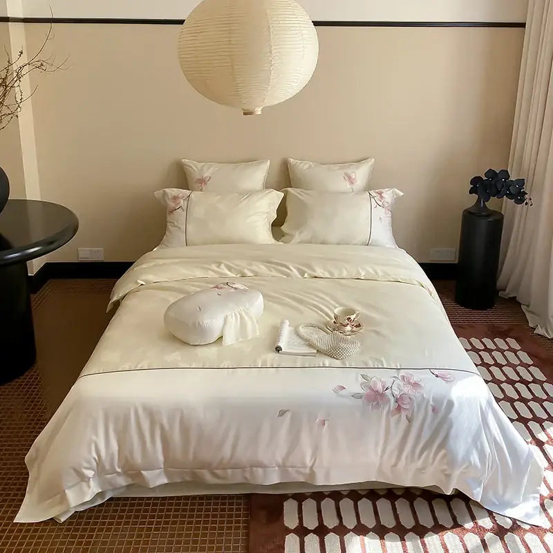 Cream-colored satin bedding set with delicate pink floral embroidery made of lyocell cotton by decorbites chinese floral