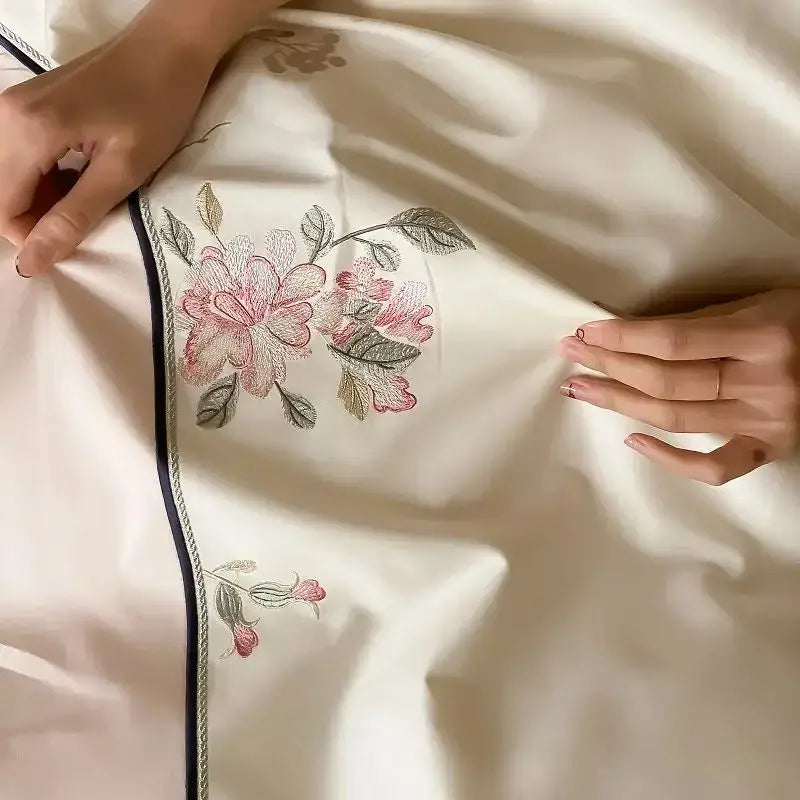 Cream-colored satin bedding set with delicate pink and green chinese flowers embroidery and navy blue decorbites chinese flowers border