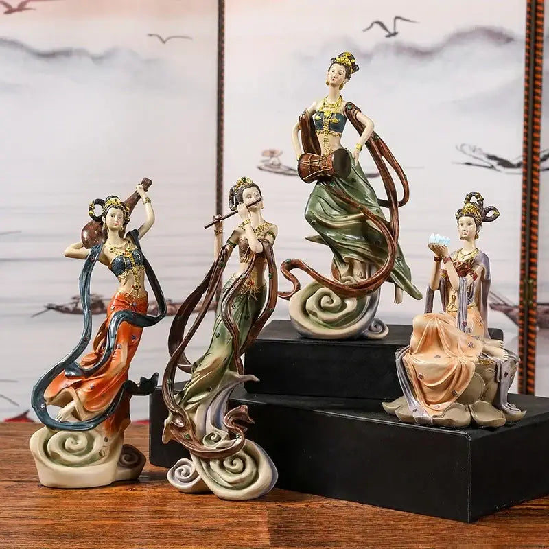 Four ceramic chinese goddess fairy figurines in flowing robes with musical instruments for home decor