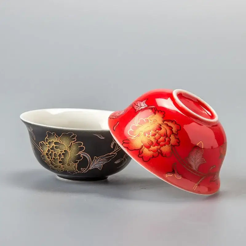 A glossy red and black porcelain dragon tea cup set featuring gold-painted peony flowers by decorbites vintage design