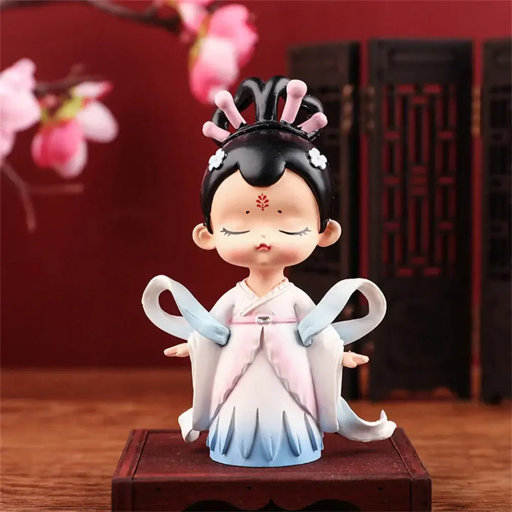 Delicate porcelain hanfu court princess figurine with black hair and flowing pale pink and blue robe for bookshelf decor
