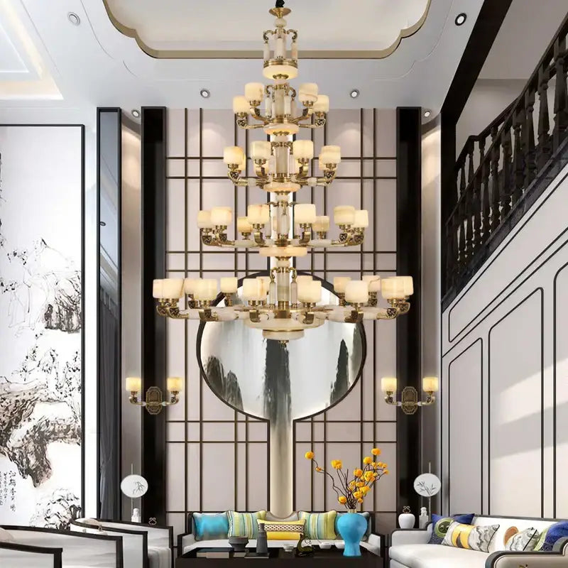 A multi-tiered decorbites jade chandelier with gold-toned metalwork and cream glass shades for modern living spaces